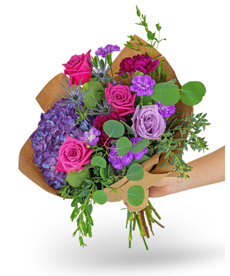 magenta flowers with green filler around them in a low glass container